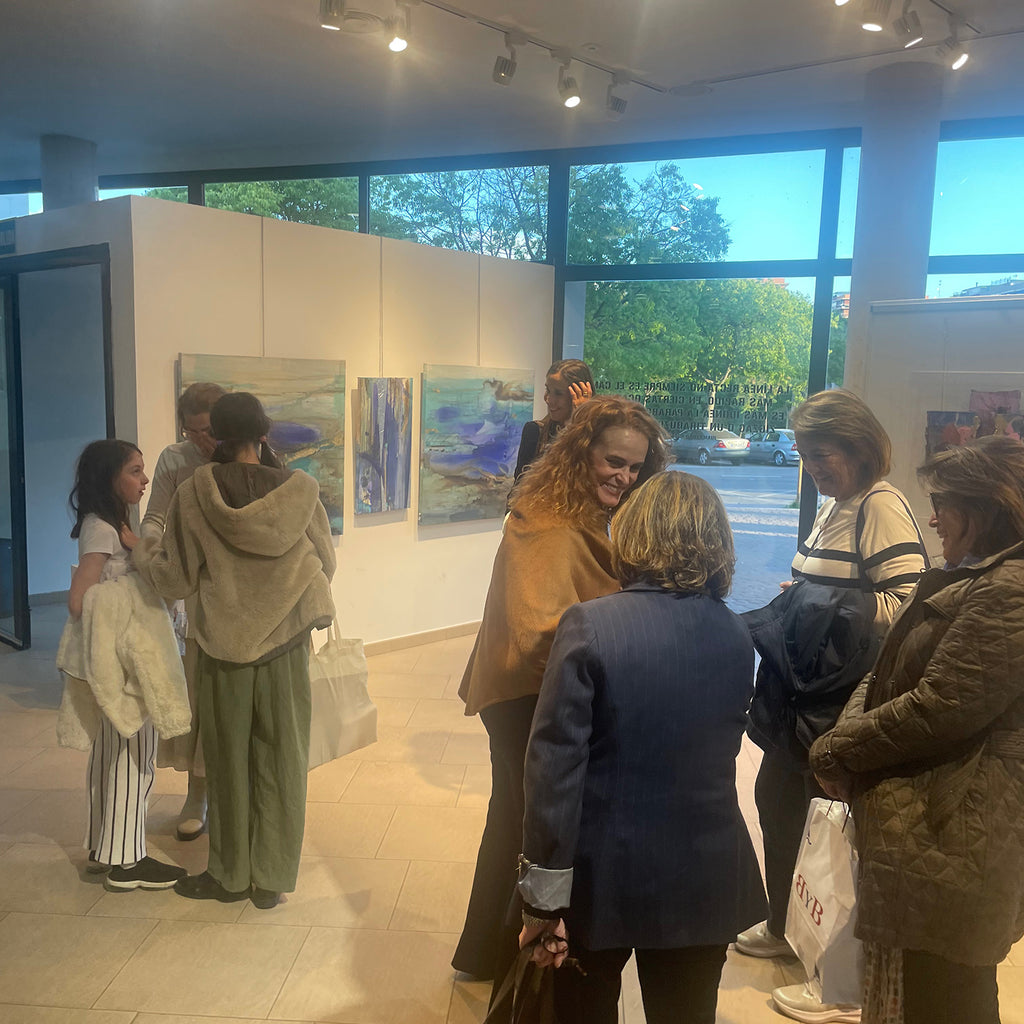 Women standing in an art gallery.