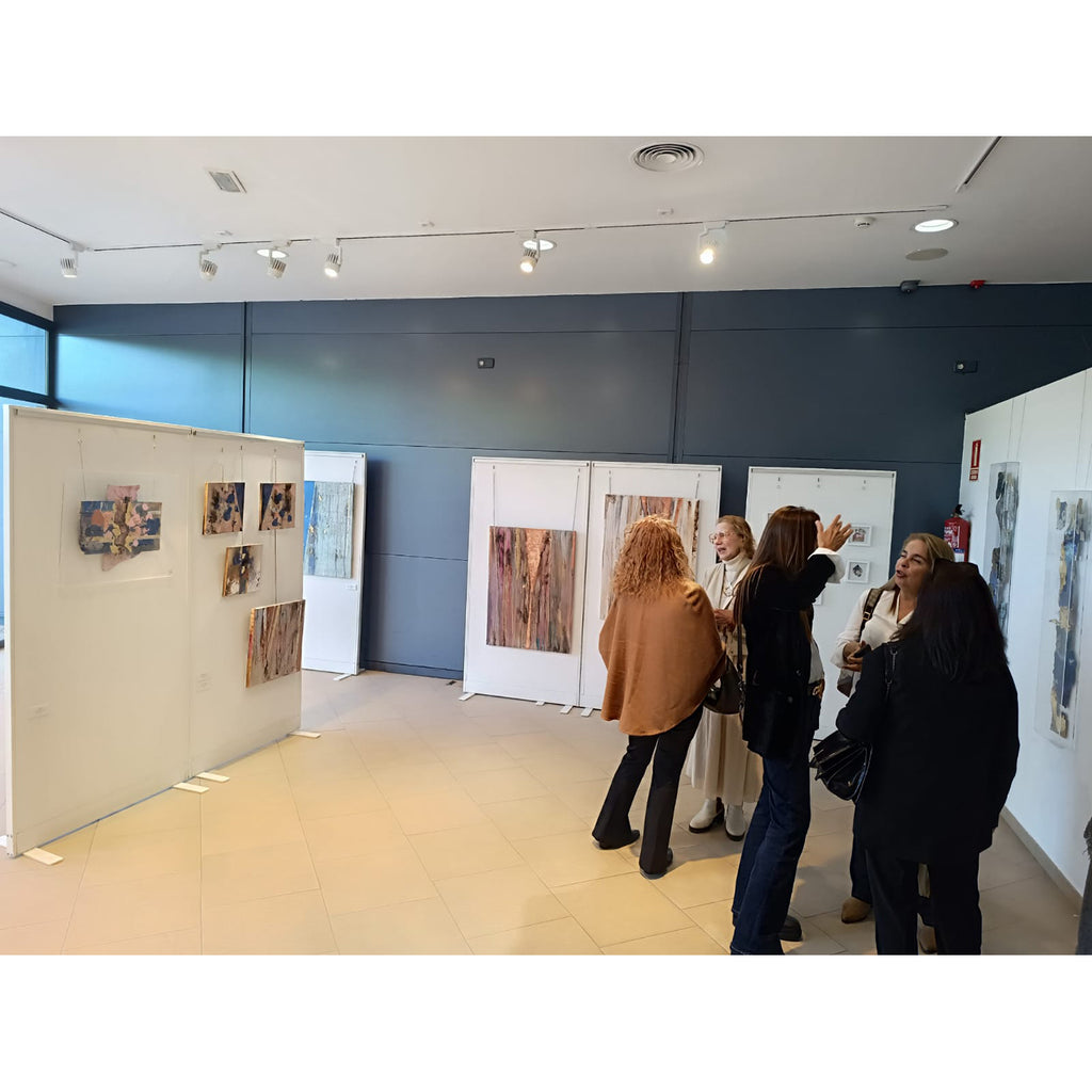 Women standing in an art gallery.