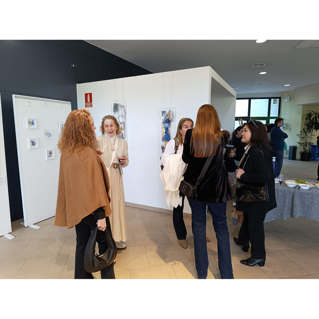 Women standing in an art gallery.